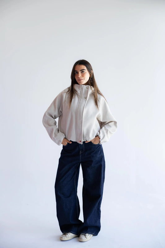 Stone beige bomber jacket styled with wide-leg jeans - full length