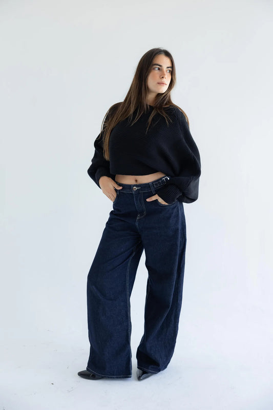Black off-shoulder pullover with dark wide-leg jeans - full length