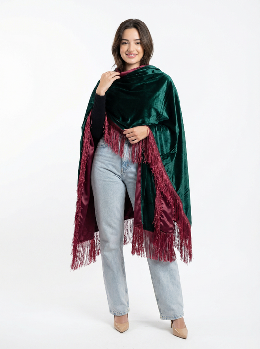 Woman wearing a green velvet shawl with red fringe on a white background