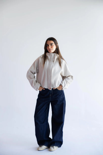 Stone beige bomber jacket styled with wide-leg jeans - full length