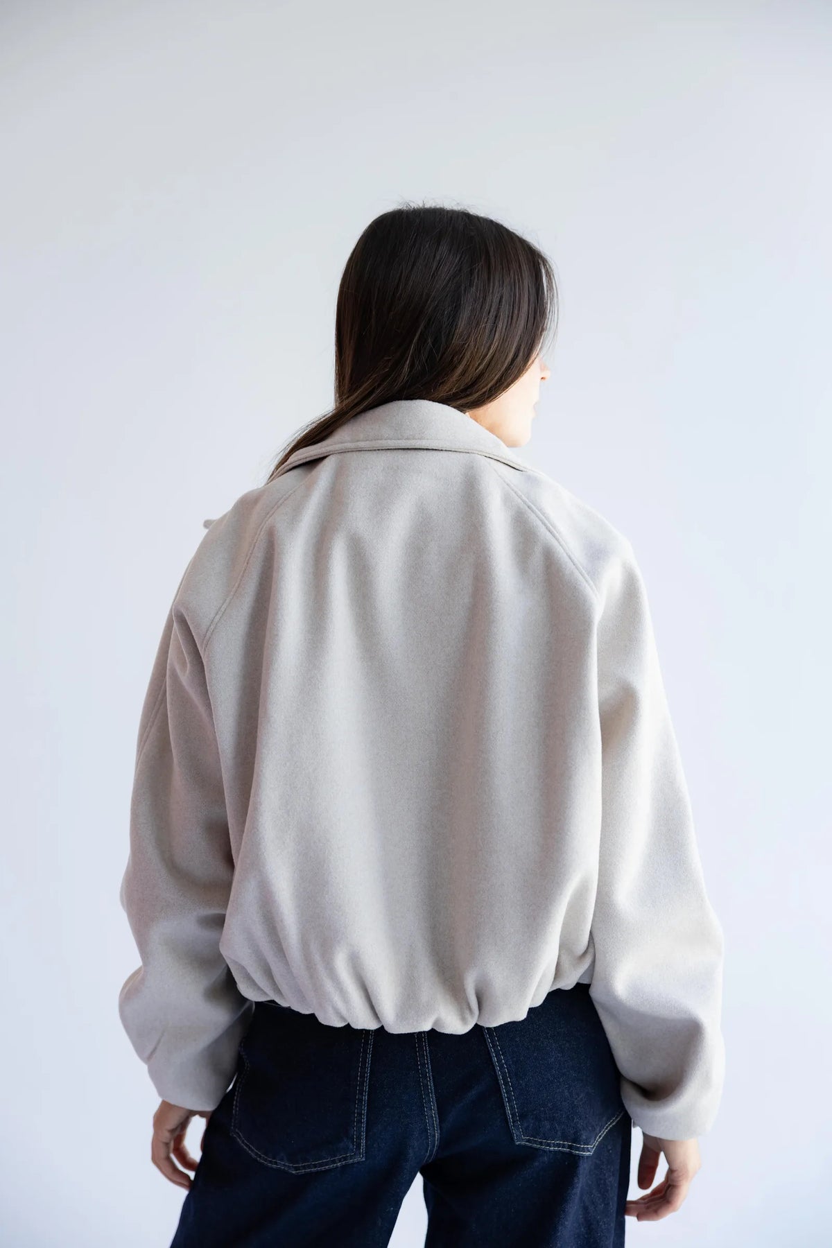 Stone beige bomber jacket - back view with elastic hem