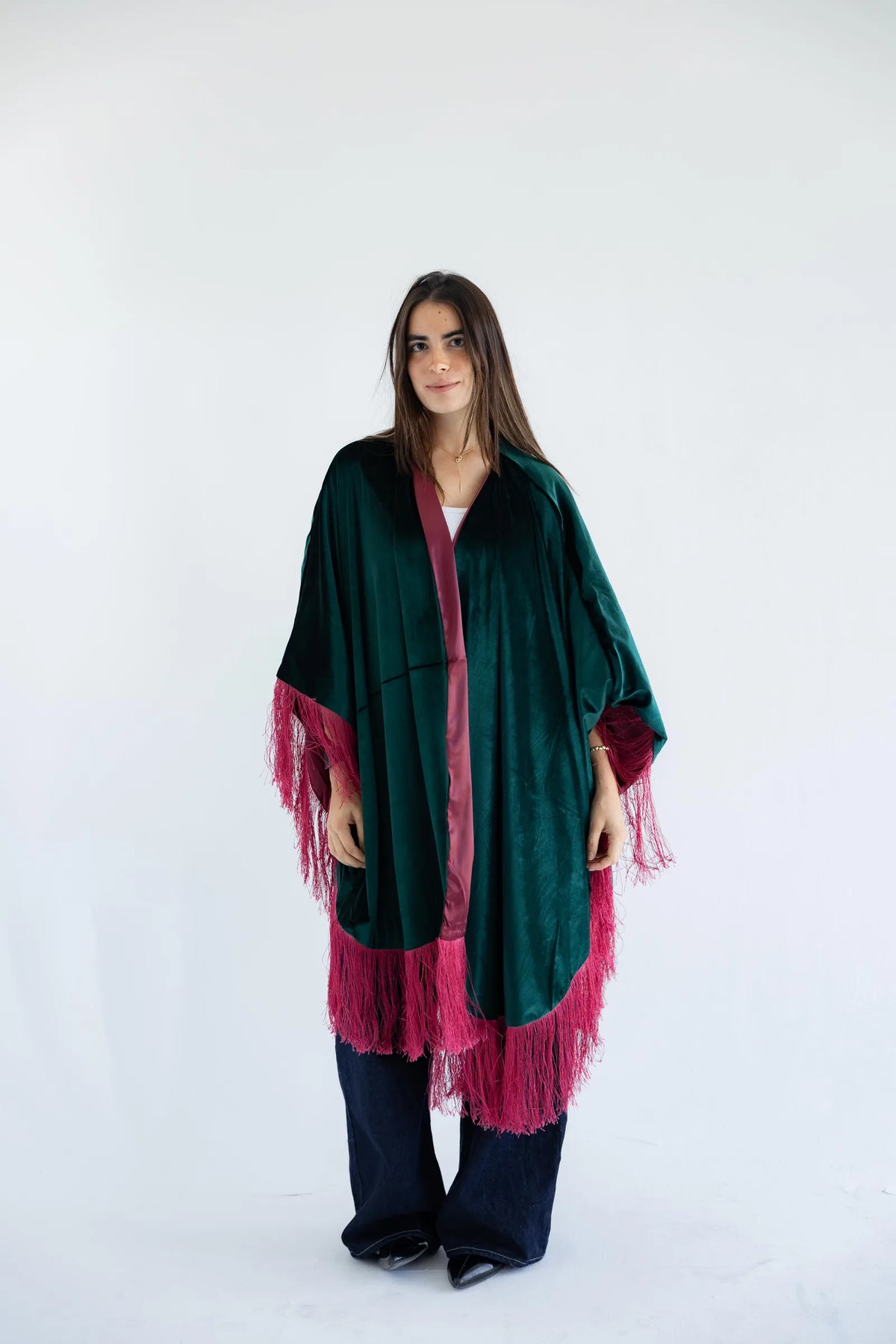 Emerald green velvet cape with fuchsia fringe - front view