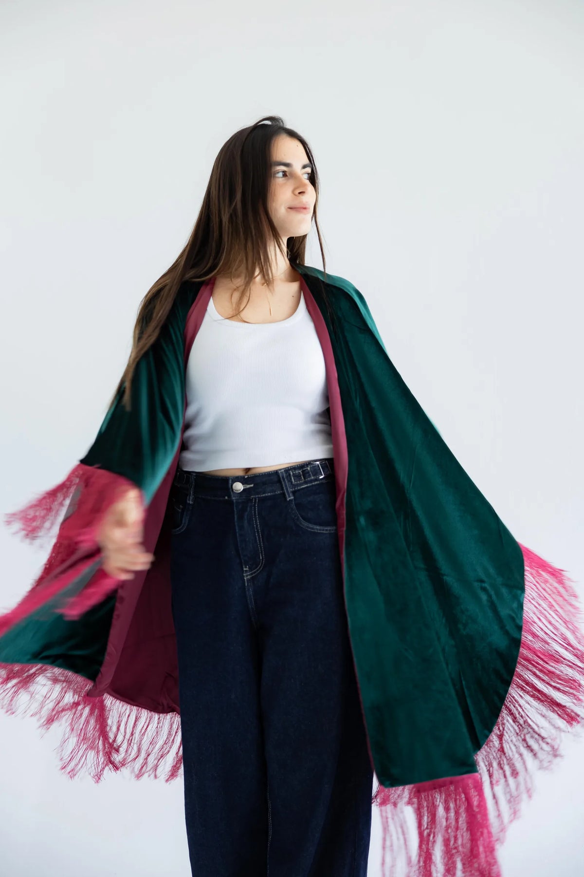 Fringed velvet cape in motion - lifestyle shot