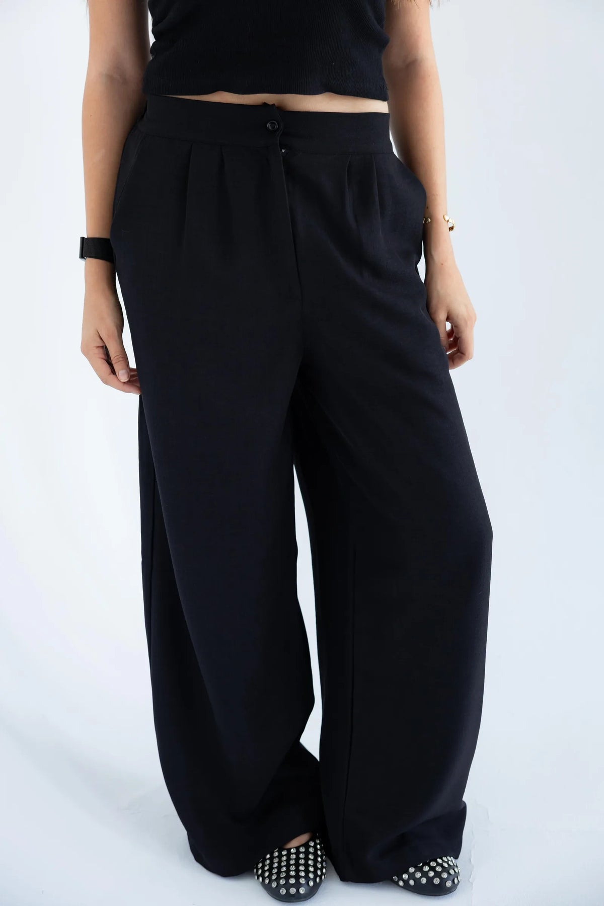 High-waisted wide-leg trousers detail
