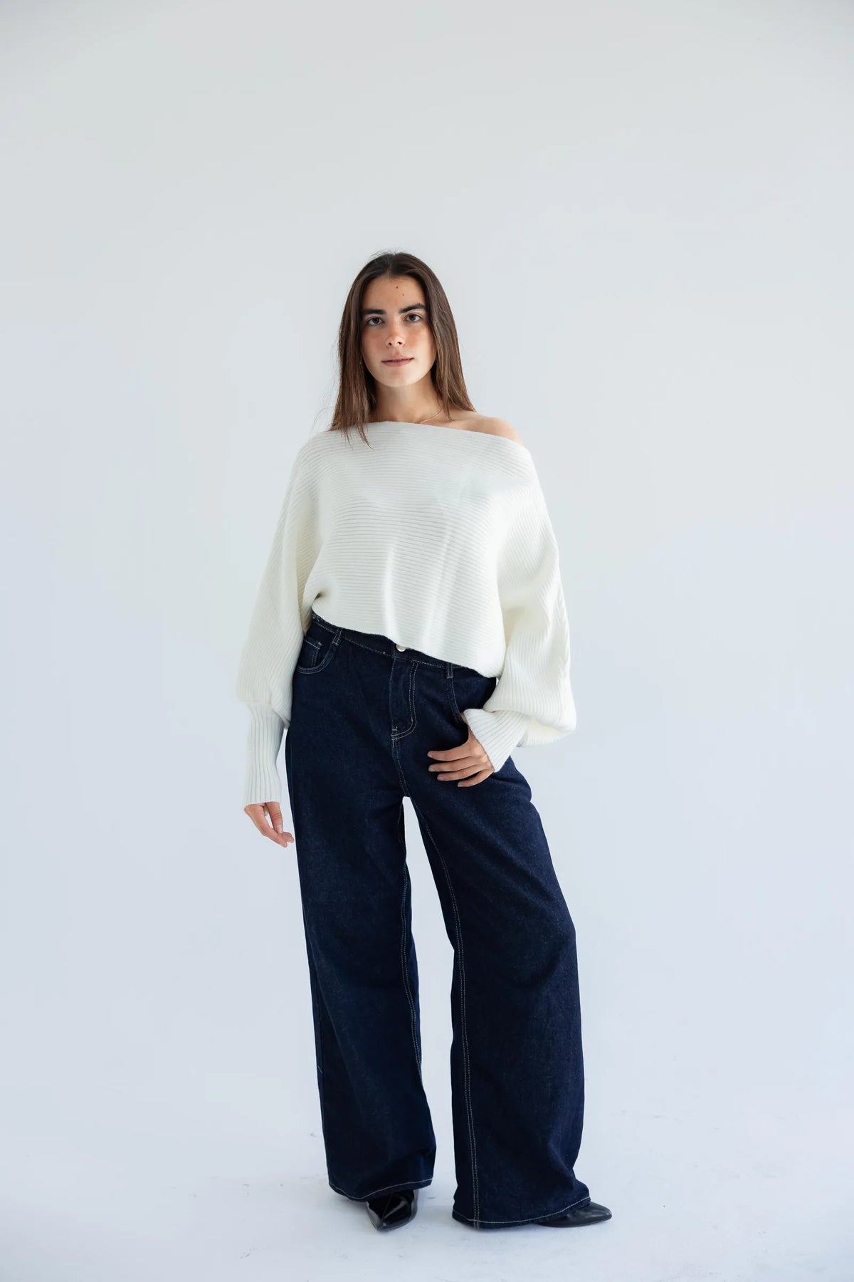 Ivory off-shoulder pullover with dark wide-leg jeans - full length
