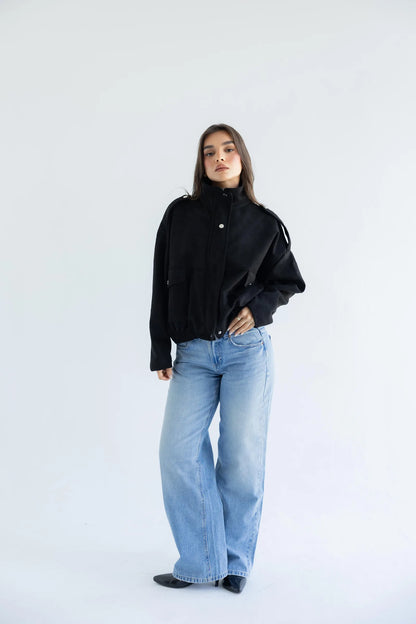 Black utility bomber jacket with light-wash jeans - full length