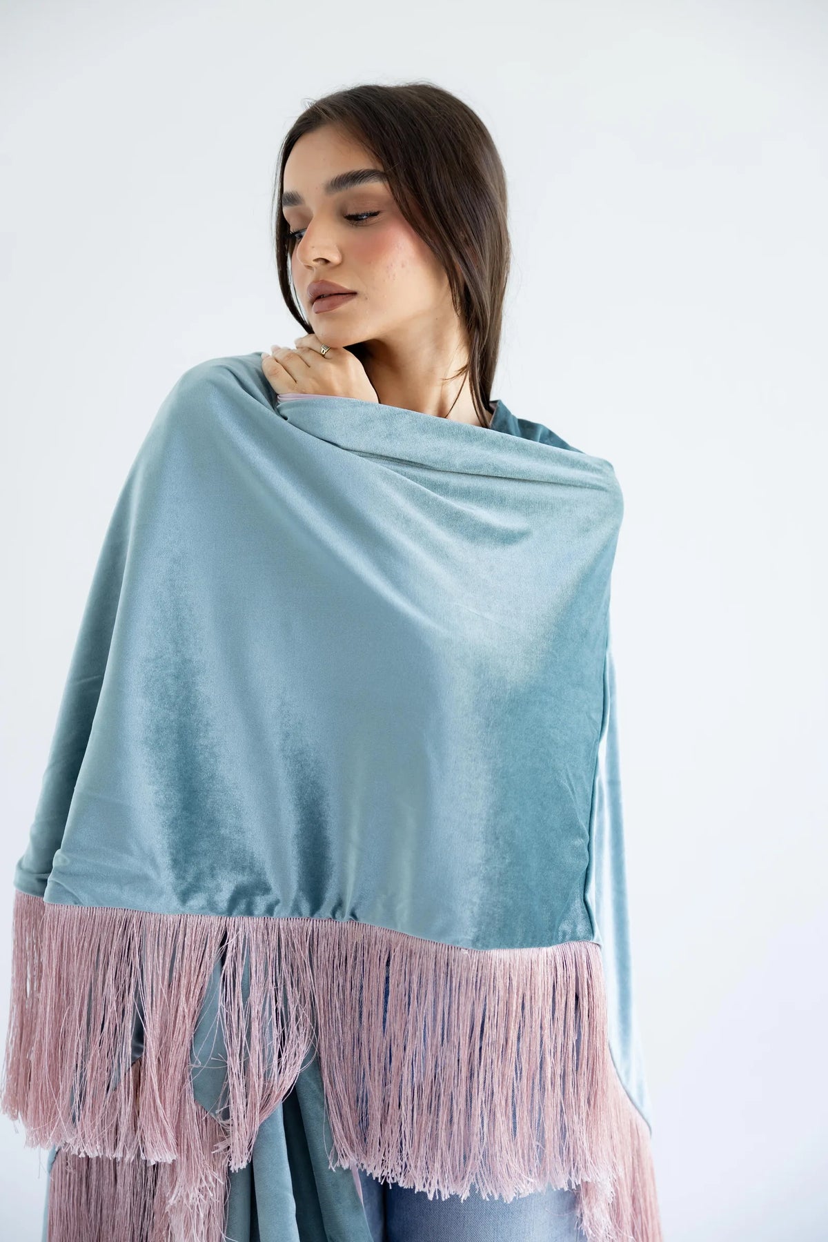 Close-up of sage velvet and rose fringe