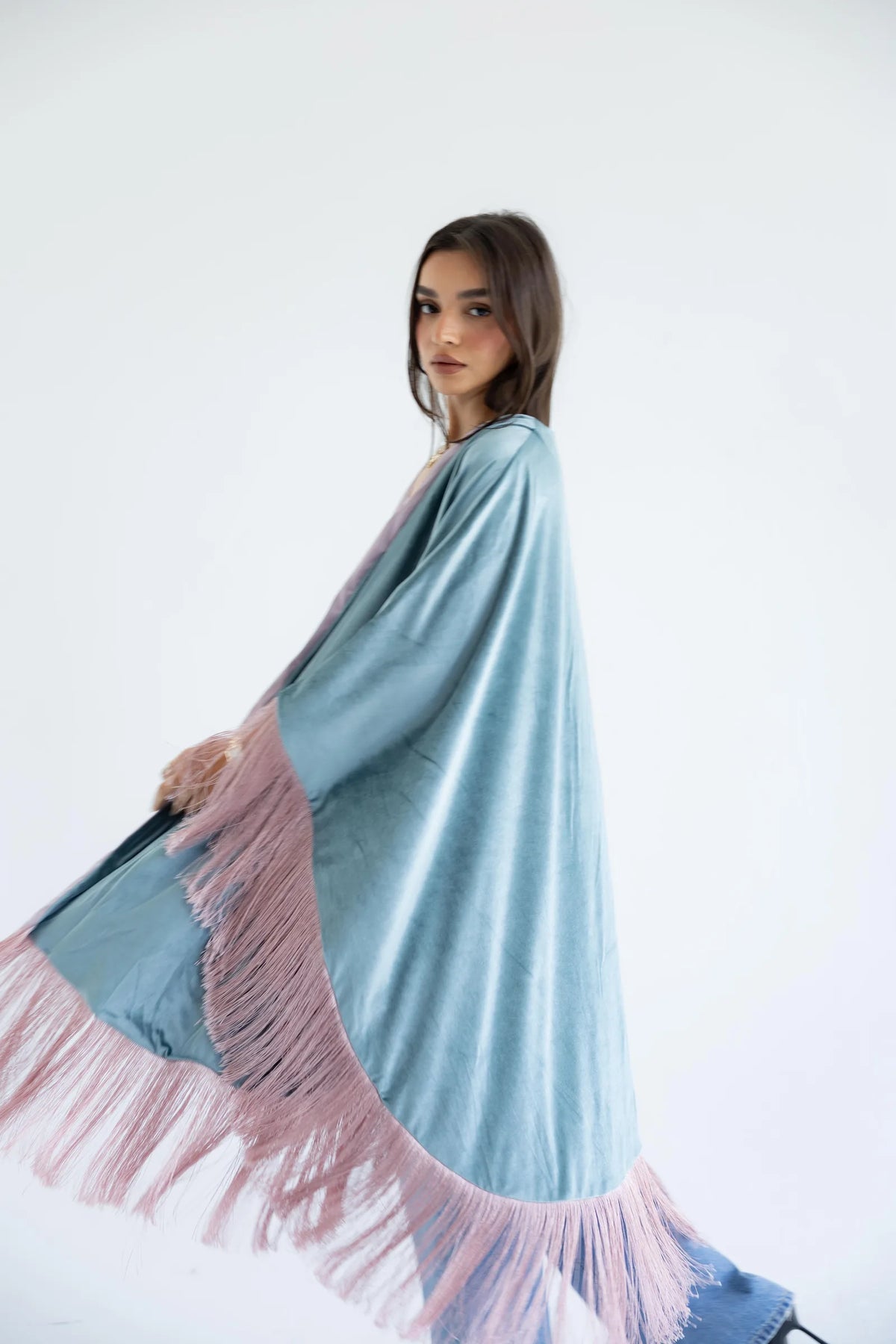 Sage and rose fringed cape in motion